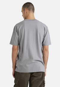 Gray short-sleeve t-shirt made of cotton, featuring a crew neck and a relaxed fit. No visible logos or patterns.