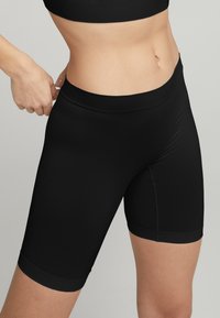 Svarta högmidjade cykelshorts i mjukt, elastiskt tyg. Har en bred midja och en figurnära silhuett.
