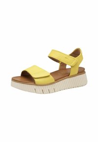 Infradito gialli con due cinturini regolabili, una soletta marrone e una suola bianca chunky con texture rigata.