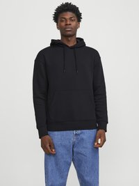 Black cotton hoodie with drawstring, front pocket, and ribbed cuffs. Paired with light blue denim jeans, displayed against a plain background.