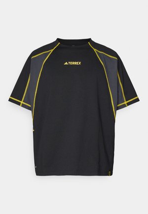 Black short-sleeve T-shirt featuring yellow stitching and accents, a round neckline, and a relaxed fit. Includes the "TERREX" logo on the front.