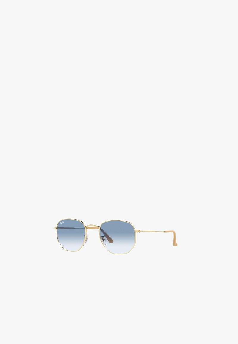 Gafas de sol de metal dorado con montura octagonal y lentes graduados en azul. Presentan patillas delgadas y extremos de goma para mayor comodidad.