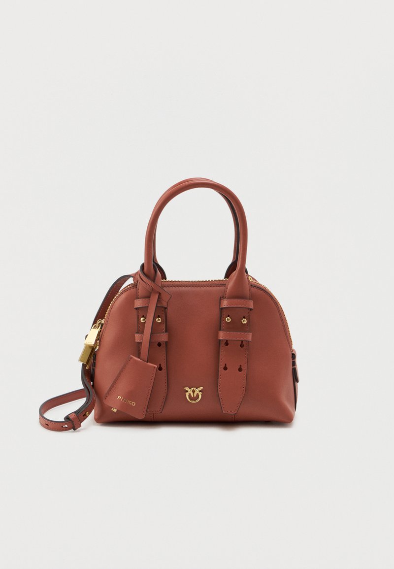 Bolsa de couro castanho com acessórios em dourado, alças duplas e uma alça de ombro destacável. Apresenta um fecho com zip e tiras decorativas.