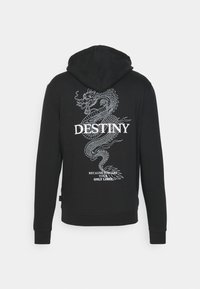 Sudadera con capucha negra con gráfico de dragón blanco y el texto "DESTINO" y "PORQUE ERES TU ÚNICO LÍMITE" en la parte de atrás.