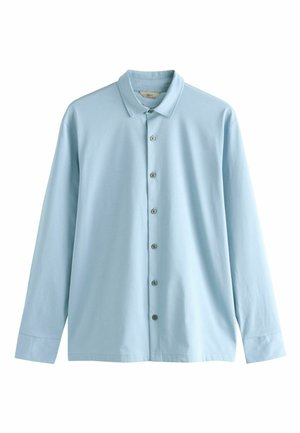 Light blue long-sleeve shirt with a pointed collar, button closure, and smooth cotton fabric. Features buttoned cuffs and a relaxed fit.