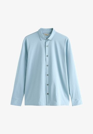 Vaaleansininen pitkähihaisessa paidassa on terävä kaulus, napitus ja sileä puuvillakangas. Siinä on napitetut hihansuut ja rento istuvuus.