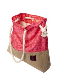 Rosa und beige Tragetasche mit Seilgriffen, Kordelzugverschluss und einem durchgehenden "SEXY"-Textmuster im oberen Bereich aus pinkem Stoff.