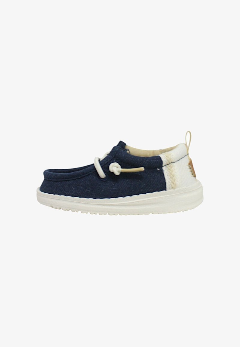 Scarpa da ginnastica in tela blu navy con suola in gomma bianca, caratterizzata da un tessuto testurizzato, punta rotonda e laccetti decorativi con un accento neutro nel tallone.