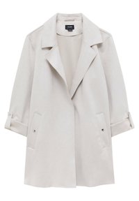 Veste pour femme beige clair à ouverture frontale, avec larges revers, manches longues retroussées et boutonnées aux poignets, et poches à rabat avec fermetures à pression.