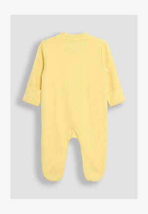 Une combinaison à pois jaunes en coton doux, dotée de manches longues, d'un col rond et d'un design avec pieds pour chaleur et confort.