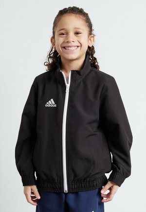 Schwarze Sportjacke mit weißem Reißverschluss und adidas-Logo. Merkmale sind elastische Bündchen und Saum, glattes Material und ein hohes Kragen-Design.