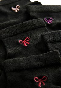Zwarte sokken hebben gekleurde geborduurde strikken in roze, paars en rood op de boorden. Het materiaal lijkt zacht met een gladde textuur.