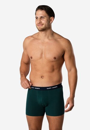 Boxers en vert foncé en tissu doux, présentant un ajustement près du corps et une ceinture noire contrastante avec le texte "HAPPY SHORTS".