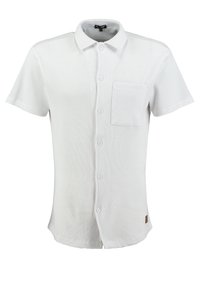 Camisa de manga corta con cuello en blanco, con tejido texturizado, cierre de botones, un bolsillo en el pecho y un acento de logo en el lateral.