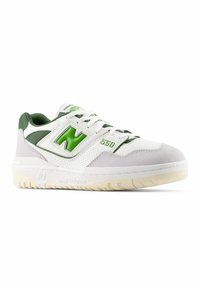 White sneaker with green accents, featuring a textured upper, perforated details, and a prominent green 'N' logo on the side.
