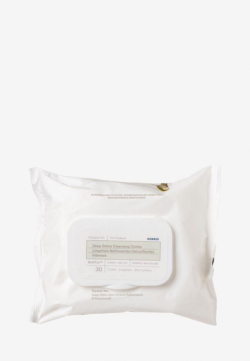 Vit förpackning med en märkt framsida som visar "Deep Detox Cleansing Cloths", med en rund, blank stängning och text på flera språk.