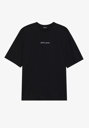Black cotton t-shirt with a loose design. Features short sleeves and a rounded neckline. Text "Positive Sincere" in white centered on the front.
