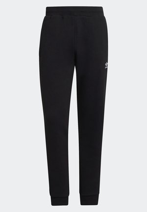 Sorte sweatpants med smal pasform, elastisk talje og manchetter, sidelommer samt en lille hvid Adidas-logo på venstre lår.