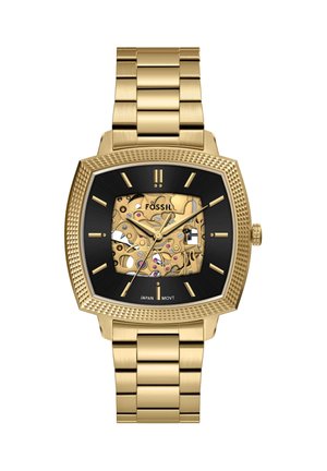 Goldene Metallarmbanduhr mit schwarzem quadratischem Zifferblatt, sichtbaren komplexen Zahnrädern und goldenen Stundenmarkierungen, Zeigern und Armband.