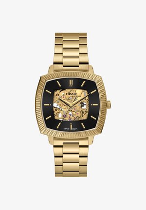 Goldene Metallarmbanduhr mit schwarzem quadratischem Zifferblatt, sichtbaren komplexen Zahnrädern und goldenen Stundenmarkierungen, Zeigern und Armband.