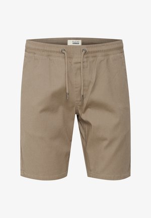 Shorts beige fabriqués en tissu léger. Dotés d'une taille élastique avec cordon de serrage, de poches latérales et d'une coupe droite.