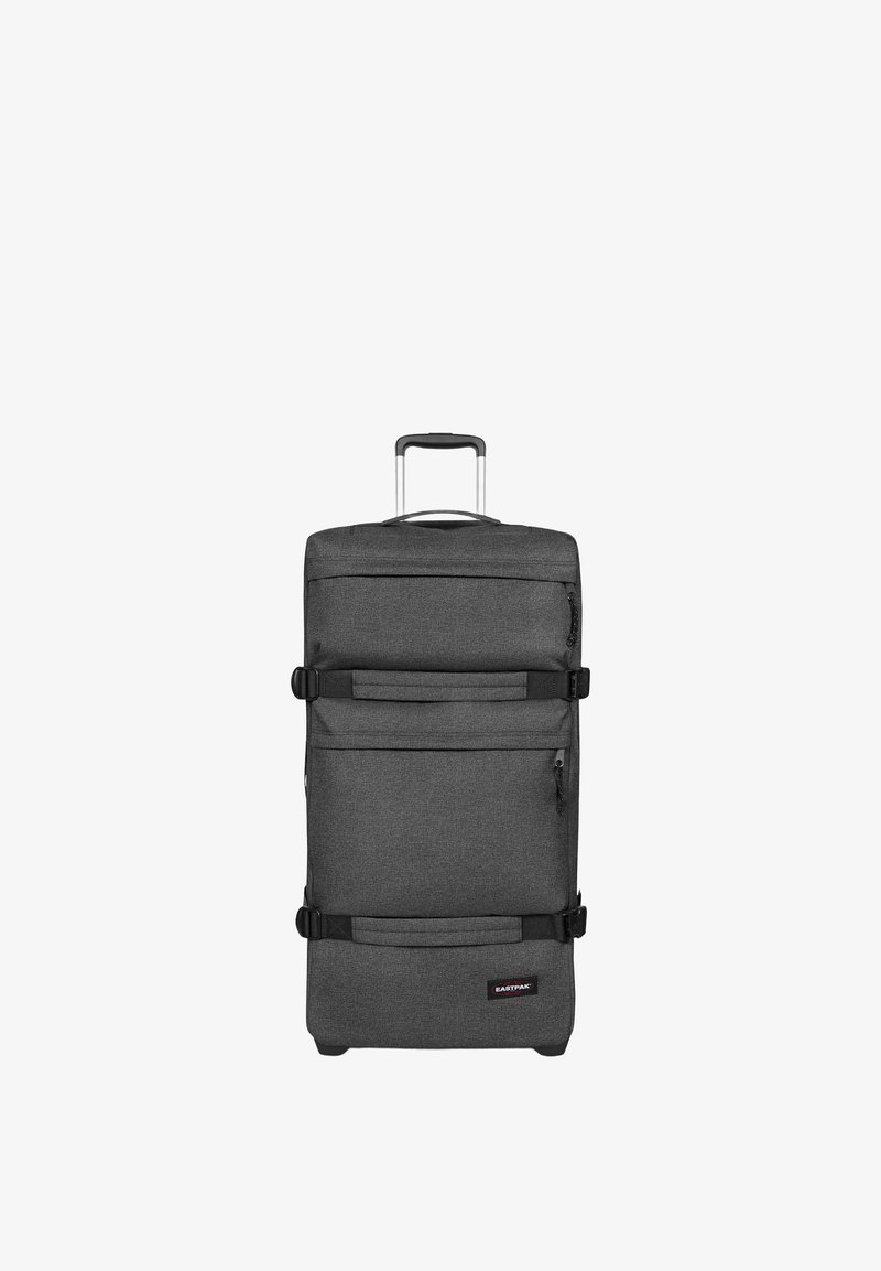 Valise souple à roulettes gris foncé avec poignée télescopique, poches avant zippées et deux sangles de compression horizontales.