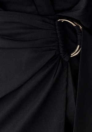 Black fabric with a smooth texture, featuring gathered details and a gold circular ring accent integrated into the waistband design.