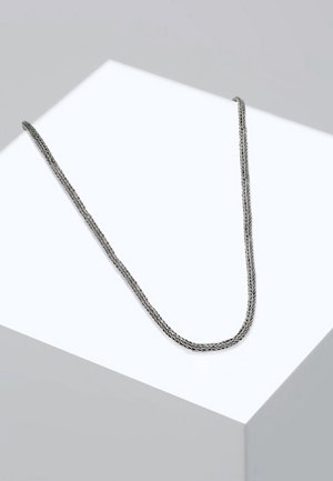 Silver braided chain necklace with a smooth texture, featuring a classic design and a subtle shimmer, resting on a white display surface.