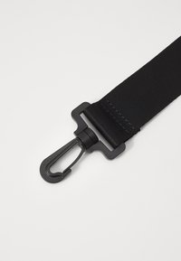 Black nylon strap with a matte black metal clip and hardware, featuring a textured finish and sturdy stitching along the edges.