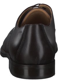 Schwarze Leder-Dressschuhe, runde Form, glatte Textur, mit niedrigem Absatz und dezenten Nähten. Schnürung oben für einen sicheren Sitz.