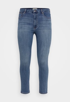 Blue denim jeans with a slim fit, five pockets, button closure, and a slight fade in color. Ankle-length with a clean hem.