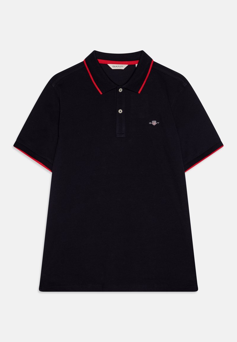 Sötétkék poloing piros gallérral és ujjakkal. Három gombos kivágással és hímzett logóval a mellrészen. Pamut anyagból készült.