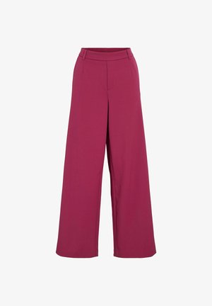 Weit geschnittene Hosen in einem satten Magenta. Hergestellt aus weichem Stoff mit glatter Textur. Verfügen über eine Taille mit mittlerer Höhe und maßgeschneiderte Vordertaschen.