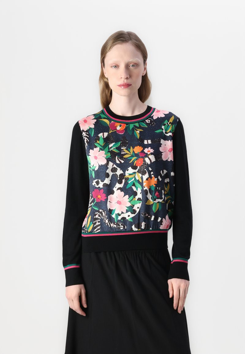 Black sweater with a floral-patterned front featuring pink, green, and red accents. Ribbed neckline and cuffs with striped details.