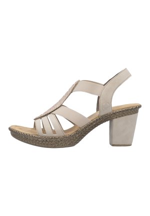 Sandale beige pour femme à bout ouvert avec des lanières élastiques, semelle tressée texturée et talon bloc épais.