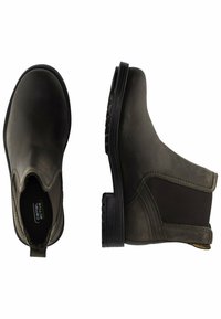 Braune, elastische Stiefeletten aus glattem Leder mit einer schwarzen Gummisohle und Zuglasche für einfaches Anziehen.