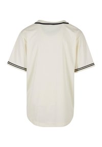 Tricou crema cu maneci scurte, cu guler rotund, avand dungi negre de accent pe maneci si un design relaxat, drept.
