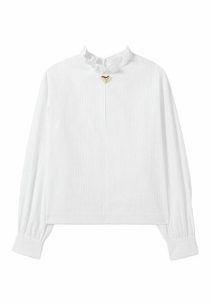 Blusa bianca a maniche lunghe con scollatura a volant e un piccolo dettaglio a forma di cuore dorato al centro, caratterizzata da righe verticali.