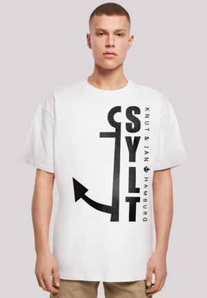 White cotton t-shirt with a loose fit, featuring bold black graphic text and an arrow design on the front.