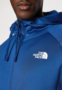 The North Face REAXION HOODED FULL ZIP JACKET - Trainingsvest - estate blue/dark heather