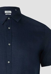 Chemise en lin bleu marine à manches courtes avec col boutonné et boutons blancs le long de la patte de boutonnage avant.