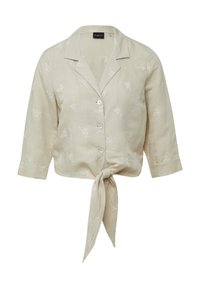 Beige linnen overhemd met een gestrikt vooraan, voorzien van witte vlinderborduring, een kraag en driekwartmouwen. Vijf knoopsluitingen.