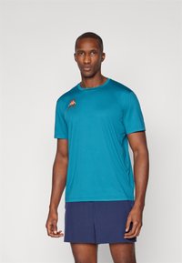 Teal korte mouwen sportshirt met een ronde hals, voorzien van een oranje logo op de linkerborst en gemaakt van een gladde, lichtgewicht stof.