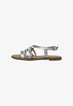 Silver flat sandals featuring multiple intertwined straps, a textured snake print accent, and a buckled ankle strap over a cork footbed.
