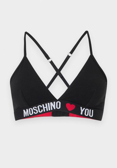 Μαύρο bralette με σταυρωτούς ρυθμιζόμενους ιμάντες και ελαστική ταινία με τα γράμματα "MOSCHINO" και "YOU" με ένα κόκκινο σύμβολο καρδιάς ενδιάμεσα.