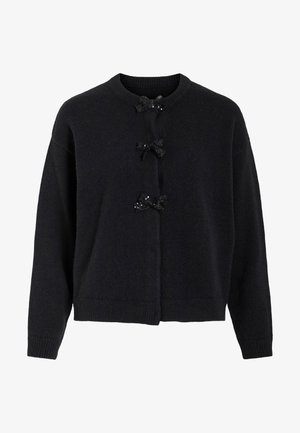 Mustapäällysteinen neulejakku, jossa on pyöreä kaula-aukko ja kolme koristeltua nappia, joissa on mustia nauhoja ja paljetteja. Rentoa istuvuutta, jossa ribbireunukset hihansuissa.