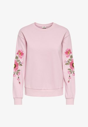 Rožinis megztinis su ilgomis rankovėmis, puoštas gėlių siuvinėjimu rožinės ir žalios spalvų atspalviais ant abiejų rankovių. Minkšta medžiaga, laisvas kirpimas.