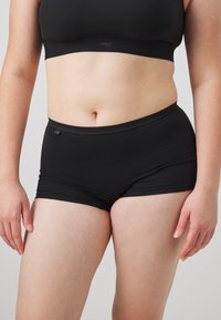 Svarta bomullsshorts med en åtsittande design, som har en mjuk midja och subtila sömnadsdetaljer. Mjuk textur och minimalistisk stil.