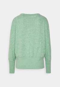 Grön, texturerad tröja med en avslappnad passform, vid halsringning och ribbade ärmslut och nederkant. Mjuk tyg med en melerad mönster.