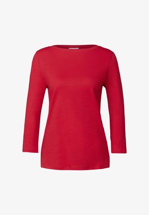 Camicia rossa a maniche lunghe, realizzata in morbido cotone, presenta un collo rotondo e un taglio rilassato, con una superficie liscia e senza motivi o dettagli visibili.